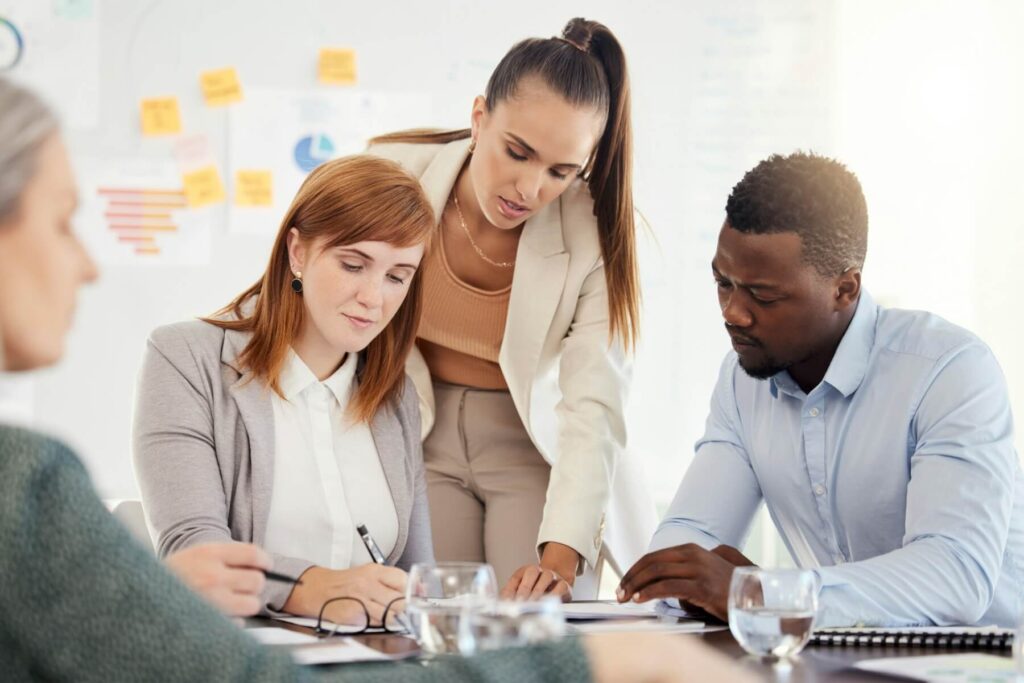 business people financial and meeting at a table with serious workers planning writing and prepar.jpg